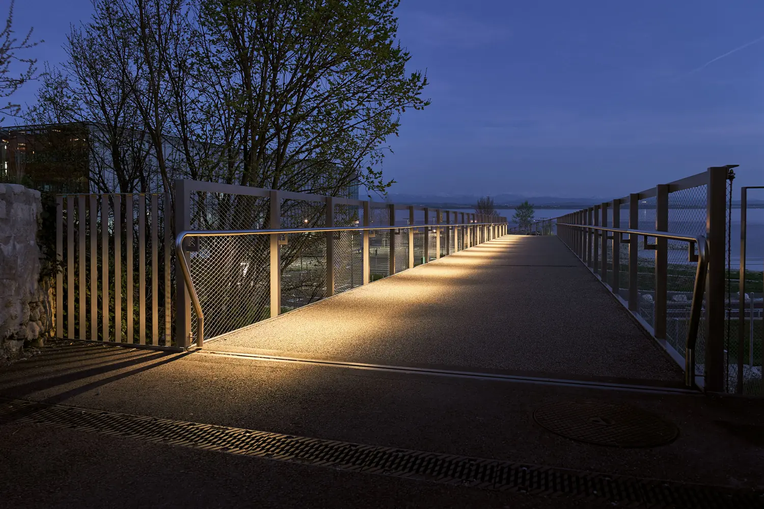 A waterfront railing at dusk